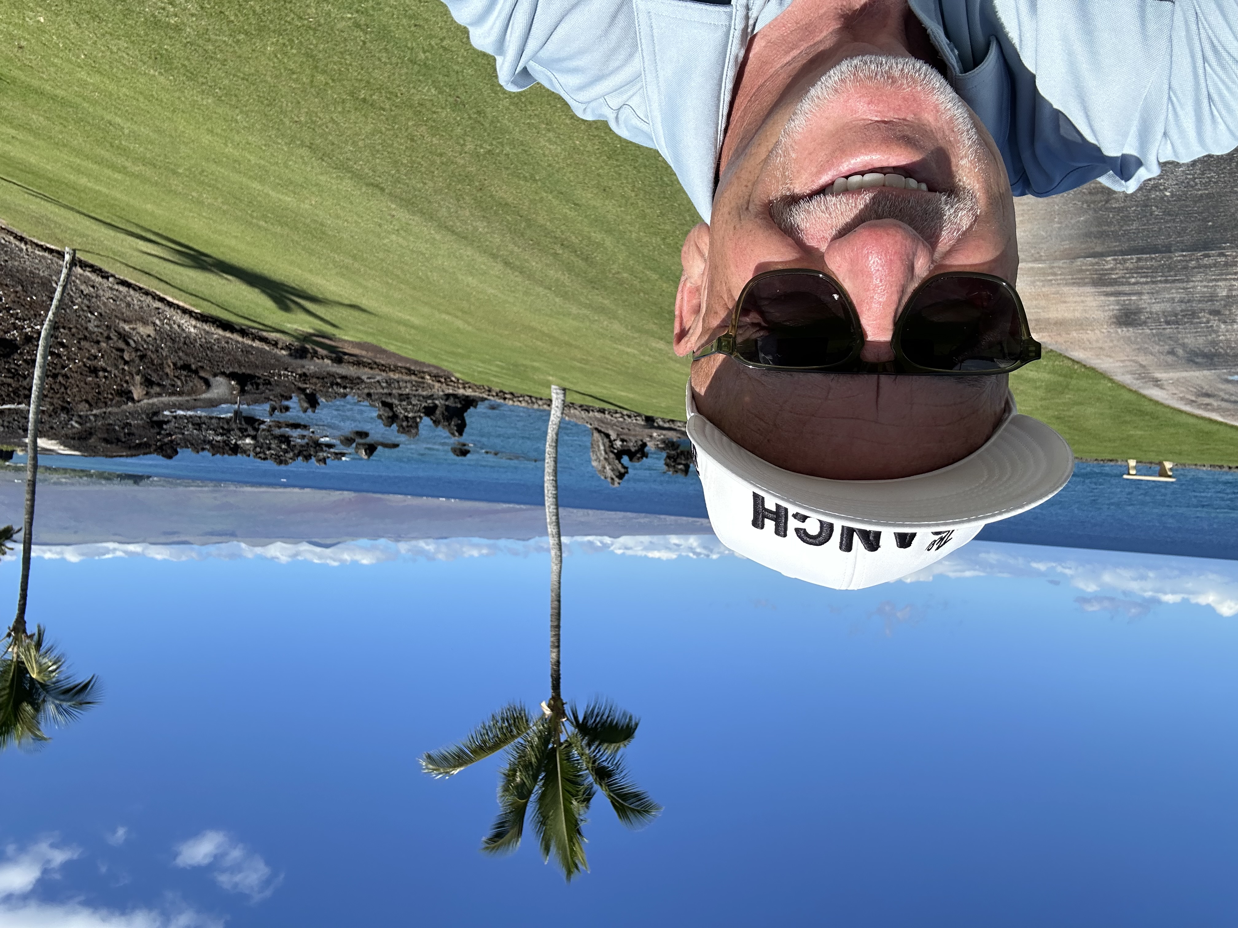 Brent under palm trees by the ocean